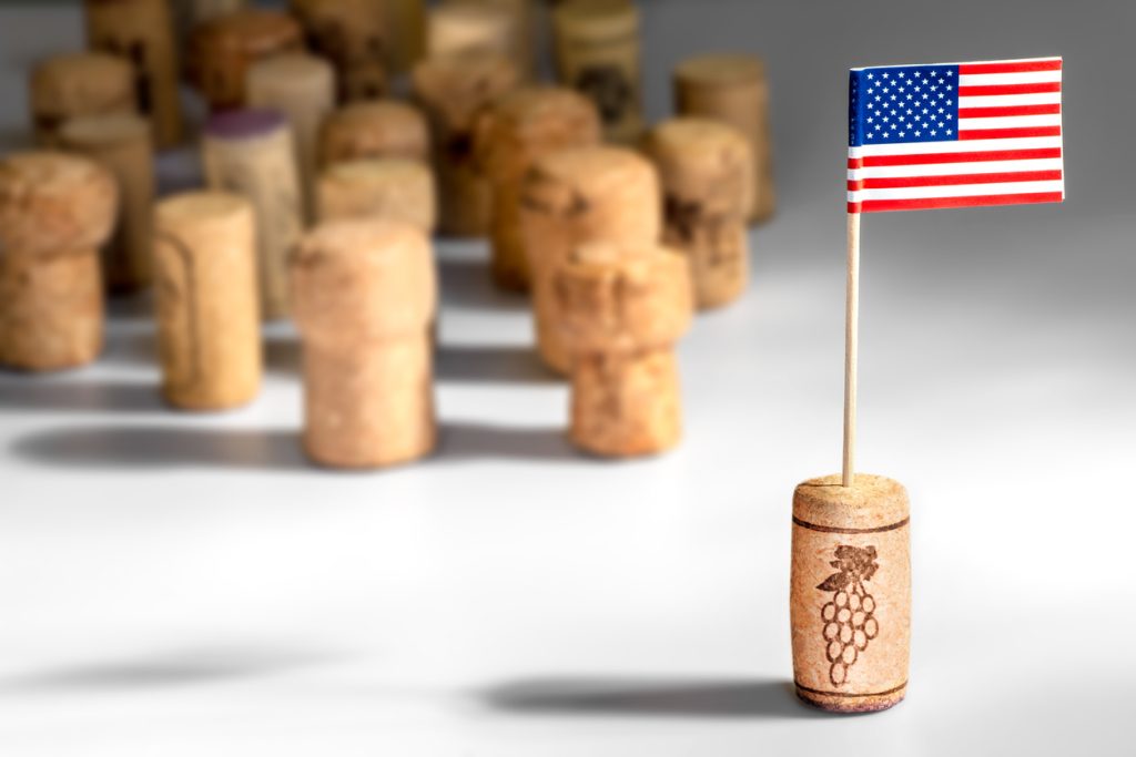 Concept of American wine industry. Close-up studio shot in selective focus of one clean wine cork with small paper American flag planted in it, with crowd of multiple different cork bottle stoppers blurred in background, on white background with light and shadow effects. There is a basic illustration of vine grape plant, created and merged by the photographer in post processing. As Trump’s latest tariffs jolt the transatlantic drinks trade, American wineries are finding themselves both burdened and bolstered. Amid global flux, Cakebread Cellars CEO Mike Jaeger explains how legacy, innovation and regional exploration are driving the next chapter in US wine.